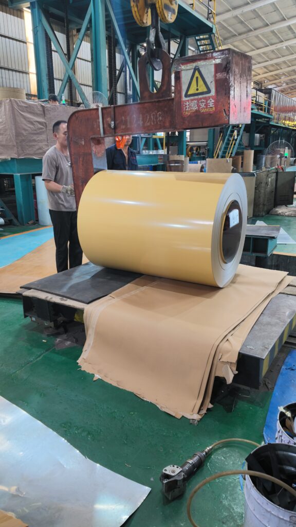 Yellow finished color coated coil lifting and packaging in manufacturing factory workshop