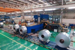 Large industrial aluminum coils stored in factory warehouse